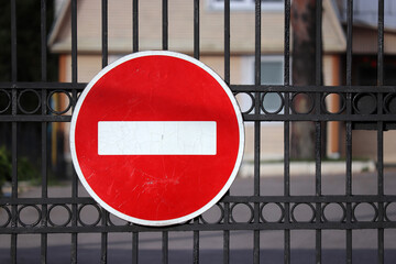Stop sign on the iron gates of private household, entry is prohibited. Concept of closed area,...