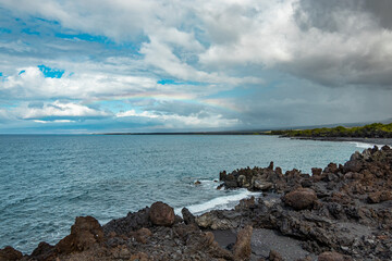 Beautiful shore. Large boulder among the waves in the sea. Hawaii