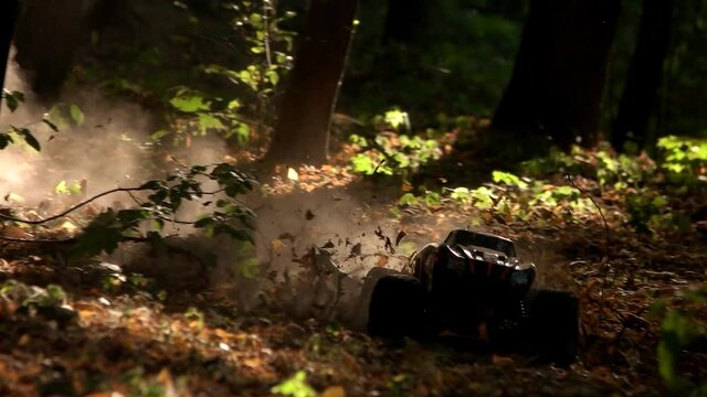 Toy monster allterrain car in the forest. Jeep on offroad race in the woods.