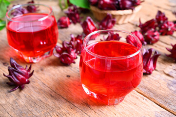 Roselle juice on wooden background, herbal organic tea for good healthy