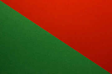 Background of red and green paper divided diagonally. Sheets of blank green and red paper with fine texture, close up.