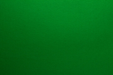 Fototapeta premium Green background. Sheet of blank green paper with texture, close up.