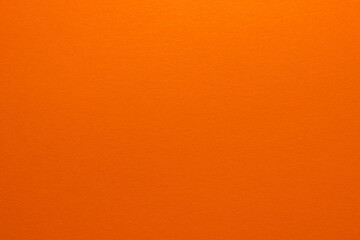 Orange background. Sheet of blank orange paper with texture, close up.