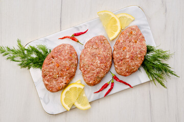 Uncooked cutlet with beef minced meat and cabbage