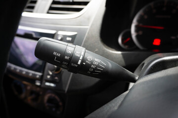Windscreen wiper control switch in car. Wipers control. Modern car interior detail. adjusting speed...