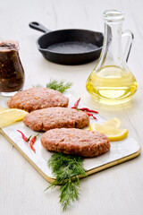 Uncooked cutlet with beef minced meat and cabbage