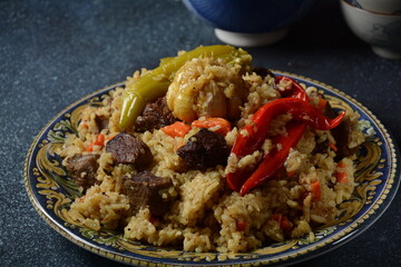 Uzbek cuisine (food) pilaf (plov palov osh) salad achichuk (achuchuk).Mutton,rice,carrots,vegetable oil,raisins,onion,turmeric,black pepper,cumin