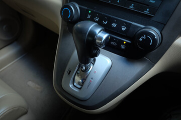 Fototapeta na wymiar automatic transmission shift selector in the car interior. Closeup a manual shift of modern car gear shifter.