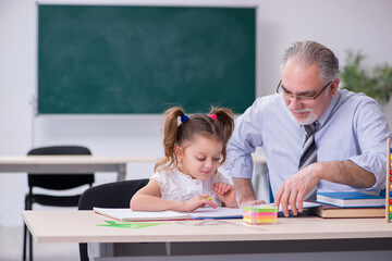 Old teacher and schoolgirl in the school