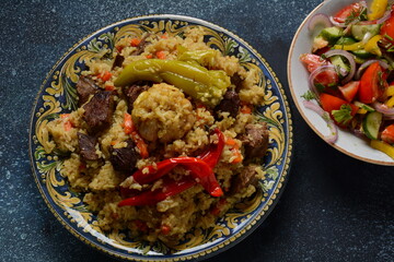 Uzbek cuisine (food) pilaf (plov palov osh) salad achichuk (achuchuk).Mutton,rice,carrots,vegetable oil,raisins,onion,turmeric,black pepper,cumin