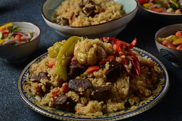 Uzbek cuisine (food) pilaf (plov palov osh) salad achichuk (achuchuk).Mutton,rice,carrots,vegetable oil,raisins,onion,turmeric,black pepper,cumin