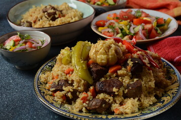 Uzbek cuisine (food) pilaf (plov palov osh) salad achichuk (achuchuk).Mutton,rice,carrots,vegetable oil,raisins,onion,turmeric,black pepper,cumin