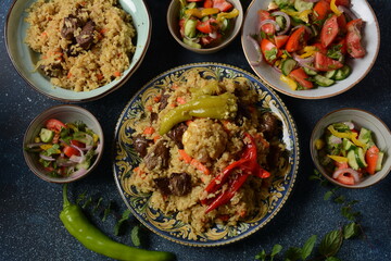 Uzbek cuisine (food) pilaf (plov palov osh) salad achichuk (achuchuk).Mutton,rice,carrots,vegetable oil,raisins,onion,turmeric,black pepper,cumin