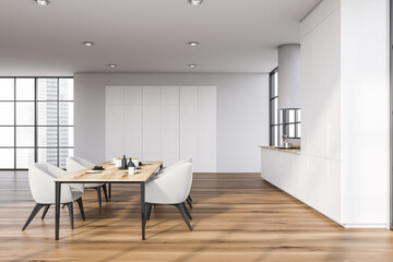 White kitchen with dining table, side view