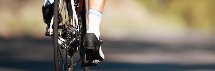 Racing- bike detail on gear wheels and feet