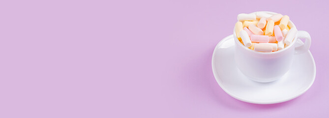 Colored marshmallow composition on purple background. Flat lay, layout and tabletop mockup with copy space.