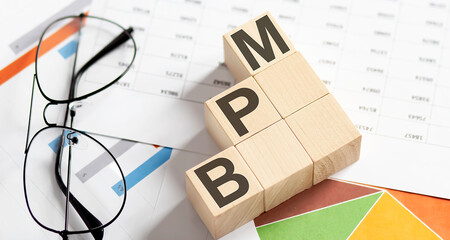 BPM words with wooden blocks. Business concept.