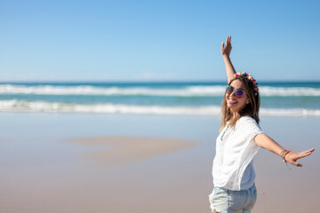 Fototapeta na wymiar Young woman spinning on the beach