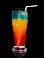 tropical fruit cocktail with ice and black background