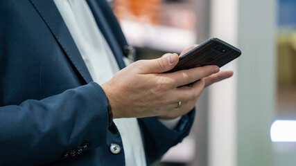 Trader Using Smartphone At Trade Fair 