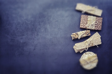 Tilt shift effect.Concept of losing weight and a healthy lifestyle. Bread roll with vegetables and herbs on table.Proper nutrition.Dry bread rolls diet.