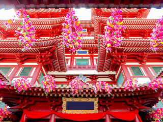 Buddhistic statues inside temple or shrine with buddhas and offerings and oblations in red and gold...
