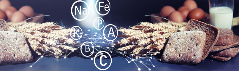 Fresh loaves of bread with wheat and gluten on a black table. Bakery and grocery concept. Fresh,...