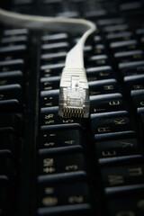 Network cable on keyboard, internet, worldwide network.
