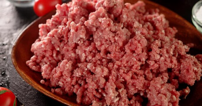 A plate full of raw minced meat on the table. 