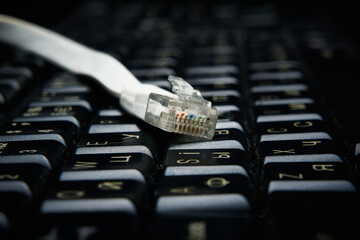 Network cable on keyboard, internet, worldwide network.