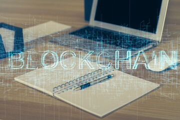 Double exposure of blockchain theme hologram and table with computer background. Concept of bitcoin...