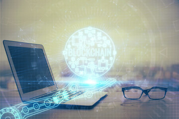 Double exposure of blockchain theme hologram and table with computer background. Concept of bitcoin...