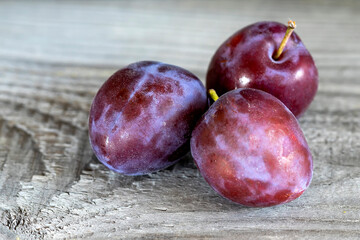 Ripe washed plums close up. Abstract background.