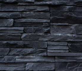texture of the building facade walls made of black and gray masonry