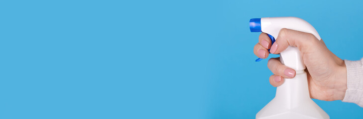 Cleaning spray bottle in hand, copy space template, banner. © Sviatoslav Kovtun