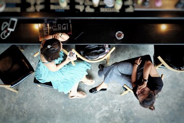 Aerial view couple of women sit and talk in the coffee shop. Lifestyle and friendship