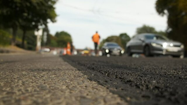 Fencing places with chips. Laying asphalt on the road. Road works. Traffic jams