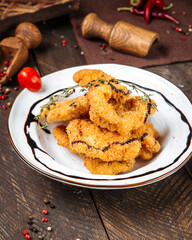 Deep fried shrimps with sauce on the wooden table