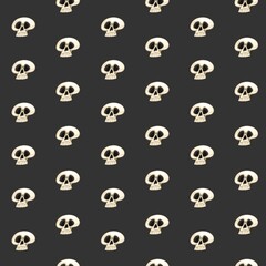 Seamless pattern from cartoon white grinning skulls on black background