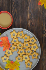 Autumn background warming cocoa drink and autumn leaves on wooden background with copy space for text or design