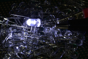 Low-power white semiconductor LEDs in a plastic semi-transparent case. Demonstration of the classic indicator for electronic systems.