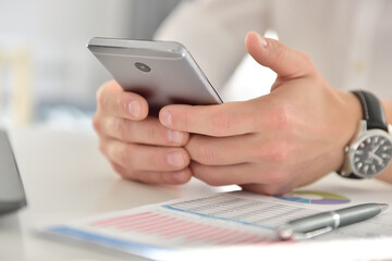 Businessman hand using mobile phone
