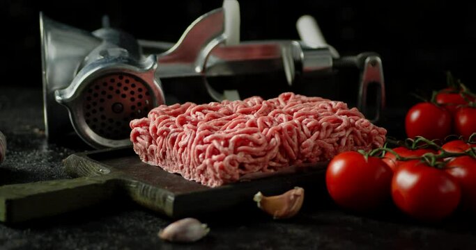 Raw minced meat with tomatoes and garlic rotates.