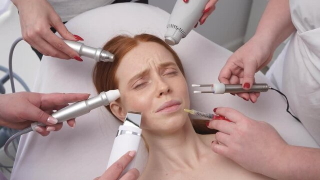 Image of a young woman, around her face many hands of cosmetologists with various cosmetic devices in a beauty salon.