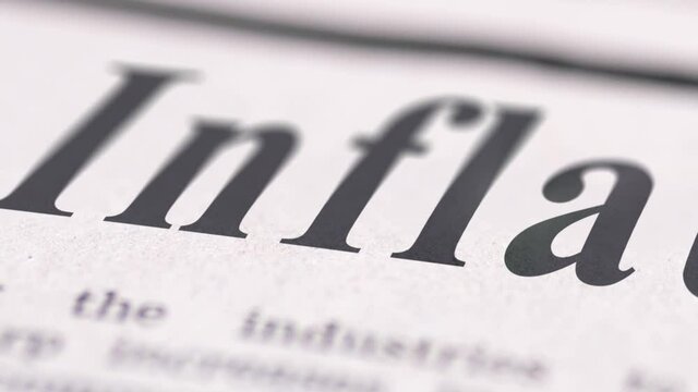 Close up footage of Inflation text written newspaper.