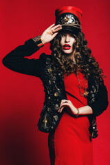 woman in red dress holding red hat