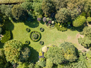 Aerial drone view. Round flower bed on the lawn.
