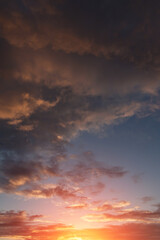 Naklejka na ściany i meble Sunset, sunrise storm sky with dark clouds, orange yellow sun and sunlight