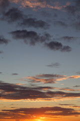 Beautiful sunrise, sunset orange yellow blue sky with clouds and sunlight background texture