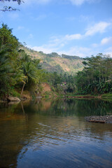 Fototapeta na wymiar Small lake with views of the hills
